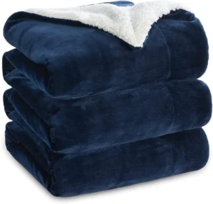 a stack of blankets with a white blanket on top