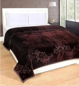 a bed with a brown blanket