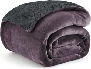 a purple blanket folded on a white background